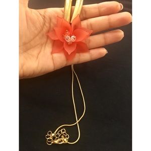Gold necklace with orange flower pendant